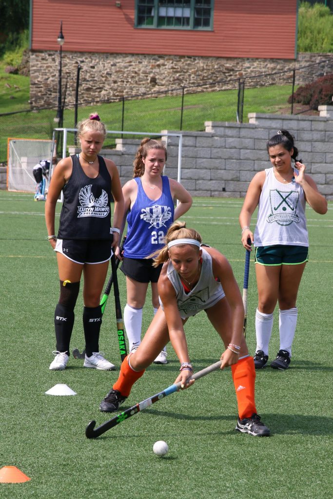 Young women practicing field hockey on a sunny day in Bryn Mawr, PA.